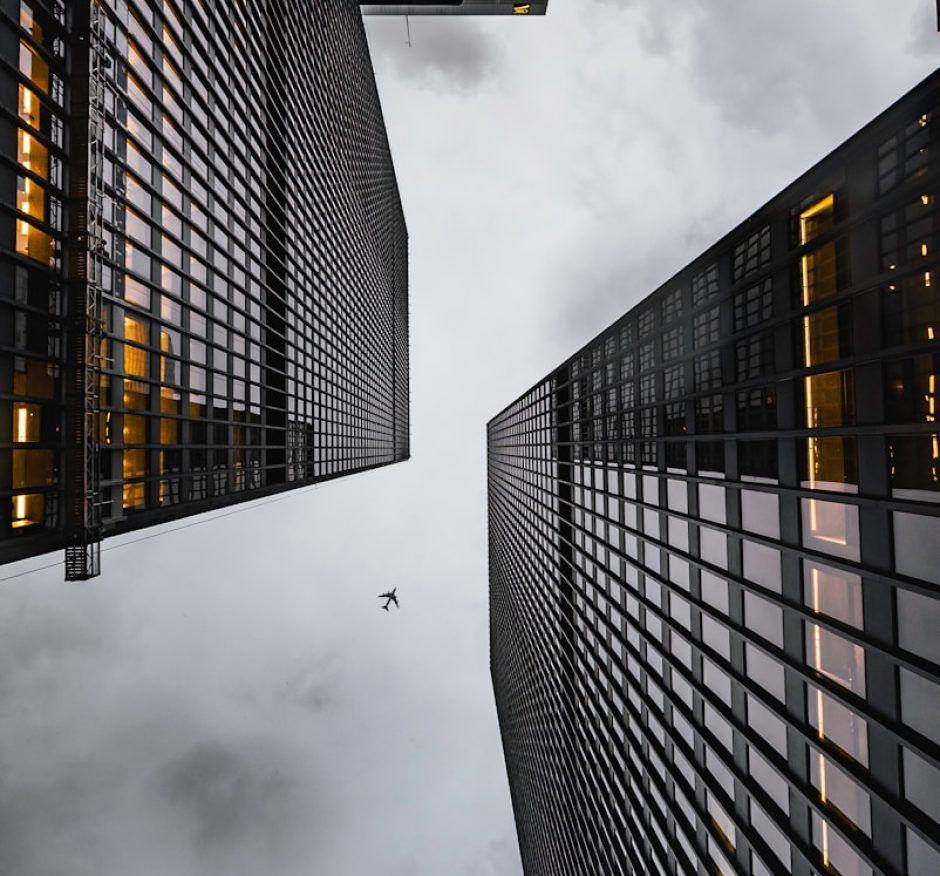 low angle photo of black high rise concrete city buildings